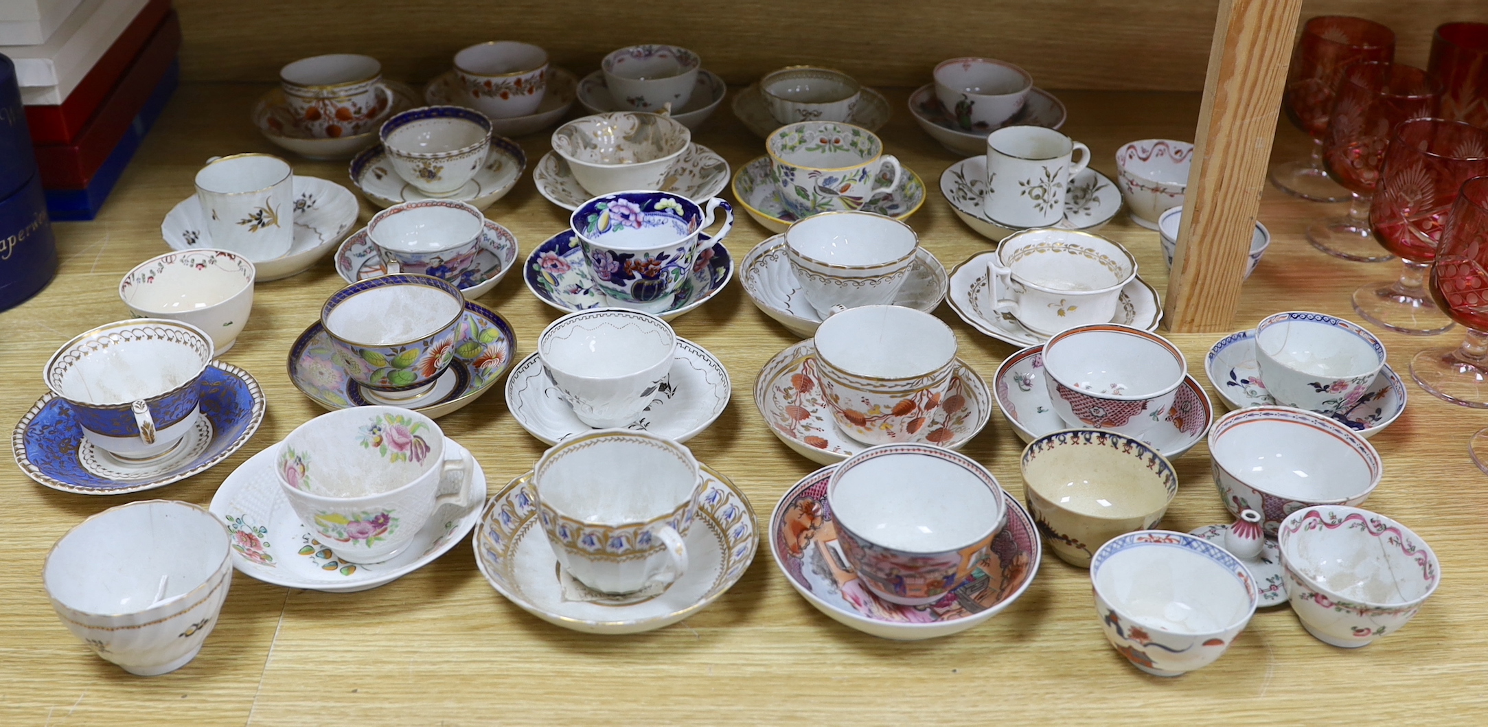 Collection of 18th/19th century English porcelain tea and coffee cups, bowls and saucers, some with hand painted and gilded decoration, the largest 15cm in diameter